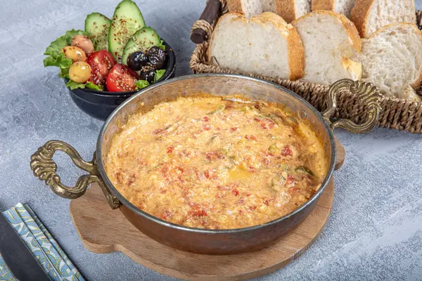 stock image Famous Turkish name menemen in traditional copper pan. Menemen made with egg, pepper and tomato. Traditional Turkish dish Menemen concept for the menu.