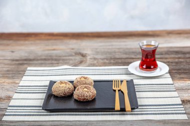 Traditional Turkish Dessert Sekerpare is also known as Chocolate Sekerpare with White Poppy Seeds, Sherbet and Pistachios. clipart