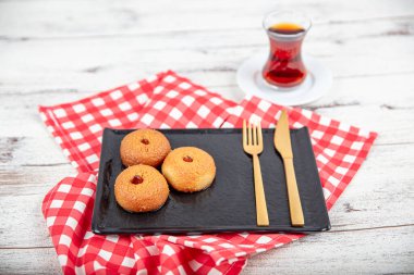 Sekerpare dessert. Ramadan dessert. Sekerpare dessert with syrup and Turkish tea on a serving plate. clipart