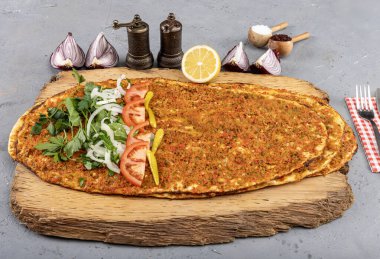 Turkish foods; Turkish pizza, Lahmacun. Turkish delicious cuisine Lahmacun pizza with minced beef or lamb meat, paprika, tomatoes, cumin spice, parsley baked spicy. clipart