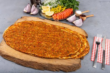 Turkish foods; Turkish pizza, Lahmacun. Turkish delicious cuisine Lahmacun pizza with minced beef or lamb meat, paprika, tomatoes, cumin spice, parsley baked spicy. clipart