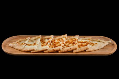 Turkish pitta with kashar cheese. Turkish pide with cheese. Pita is traditional Turkish pizza. Turkish name; Peynirli Pide. Isolated on black background. clipart