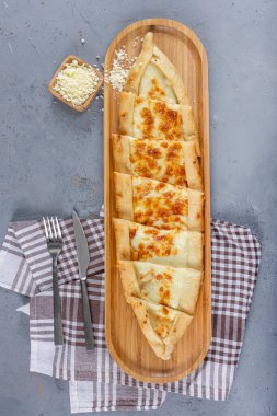 Traditional Turkish Cuisine baked dish pide. Turkish pizza pide, cheddar cheese pita. Turkish pitta with kashar cheese. Cheese baked pastry. clipart