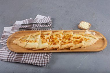 Traditional Turkish Cuisine baked dish pide. Turkish pizza pide, cheddar cheese pita. Turkish pitta with kashar cheese. Cheese baked pastry. clipart