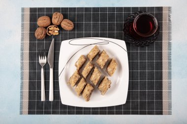 Geleneksel Türk tatlıları; el yapımı ceviz baklavası. Türkçe adı: cevizli baklava. Ahşap zemin üzerinde ceviz baklava. Türk tarzı ceviz baklavası sunumu ve hizmeti.