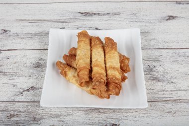 Sigara böreği. Ahşap zeminde peynirli turta. Kızarmış peynirli rulo sandviç. Yerel adı sigara boregi. Türk Purosu Şekilli Rolls. Ispanaklı ve peynirli Türk çorbası..