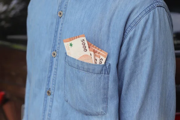 シャツのポケットの中に5000ルピアの紙幣を閉じます 財政と貯蓄の概念 — ストック写真