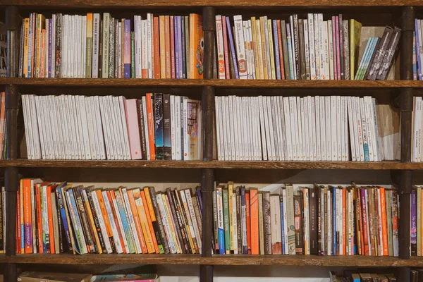 Industrial Dark Wooden Bookshelves Filled Social Fiction Self Improvement Biography — Stock Photo, Image