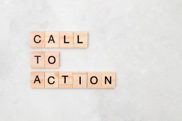 Top view of Call To Action word on wooden cube letter block on white background. Business concept
