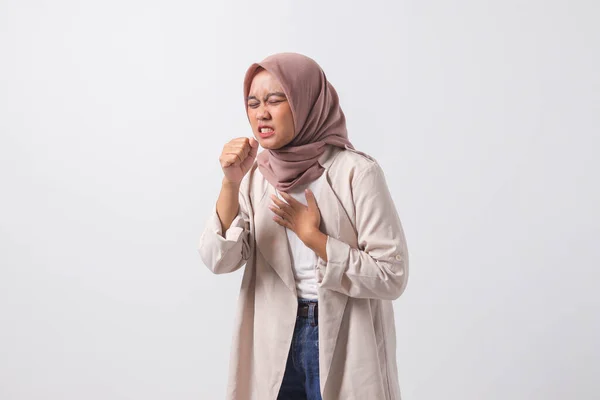 Portrait of sick Asian hijab woman in casual suit suffering with cough and feeling unwell. Businesswoman concept. Isolated image on white background