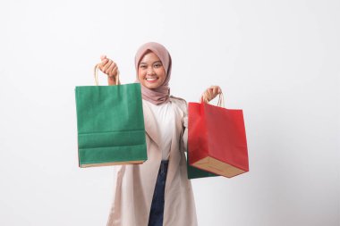 Sıradan takım elbiseli çekici Asyalı kadın portresi ve renkli kağıt alışveriş torbaları. Alışverişkolik kız ve indirim satın alma konsepti. Beyaz arkaplanda izole edilmiş resim