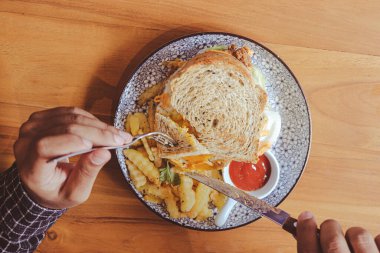 Kızarmış tavuklu tam buğday ekmekli tost, güneşli yumurta ve sos. Sabahları kahvaltı konsepti