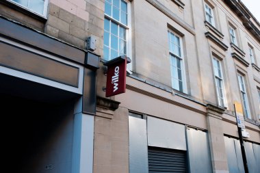 Newcastle UK: 22 Kasım 2024: Wilko ana caddesi metal panjurlu kapalı bir perakende mağazası ve gündüz vakti bir şehir caddesine park etme