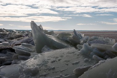 Ice hummock on the coast of the Baltic Sea. Light cloudy. Back light