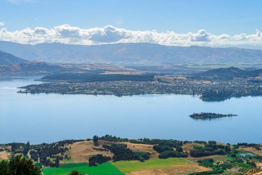 panoramic views of roys peak mountains, and wanaka lakes at background