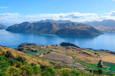 panoramic views of roys peak mountains, and wanaka lakes at background