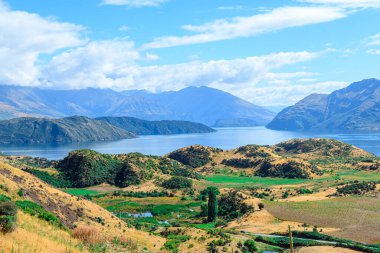 panoramic views of roys peak mountains, and wanaka lakes at background