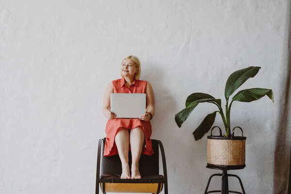 Young Blonde Woman Sitting Chair Using Laptop Front White Wall Royalty Free Stock Photos