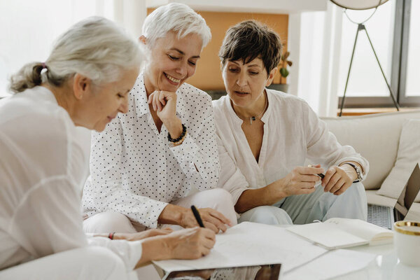Three Mature Businesswomen Talking Smiling While Working Modern Office Together Stock Picture