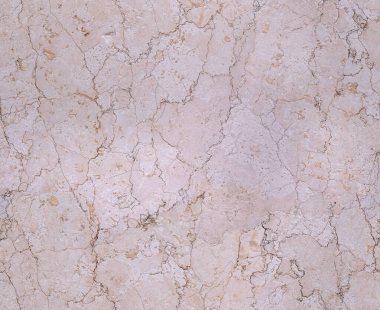 Kusursuz mermer yüzey bej döşemedeki kahverengi dallara benzeyen karmaşık desenleri ortaya çıkarır.