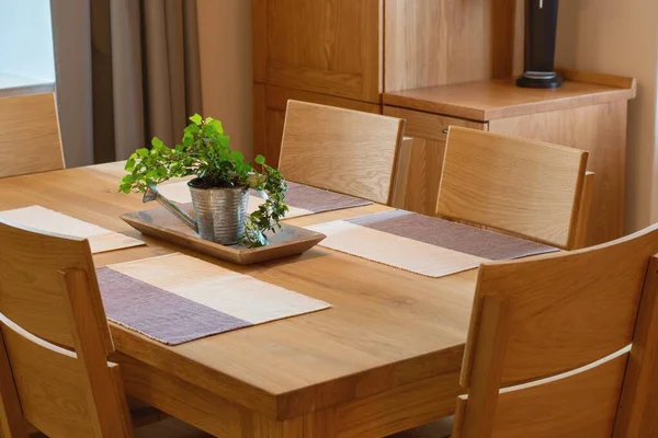 Solid wood kitchen furniture. Table and chairs, cozy home interior.