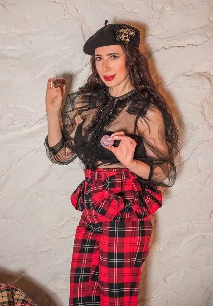 Woman in French style, wear beret and plaid pants, black blouse, fashionable concept