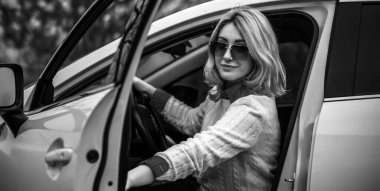 Pretty fashionable woman in automobile. Woman and car concept
