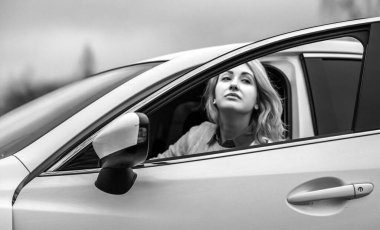 Pretty fashionable woman in automobile. Woman and car concept
