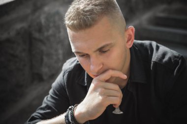 Young man in sadness or depression, grief and bad mood. Psychology problems among guys. Image sad guy thinking about something