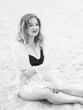 Plus size European blonde woman in stylish romantic women's summer clothes at beach. Concept of sizes, happy nice natural beautiful lady 