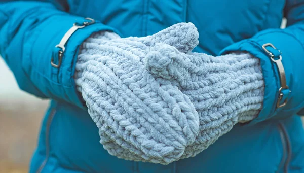 Warm grey knitted gloves. Fashionable collection of accessories for women. Detail of wardrobe