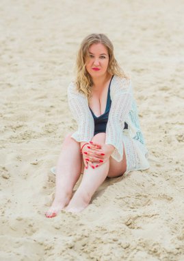 Beautiful plus size young woman rest at nature, concept of woman's life. Lady xl size having fun on a beach