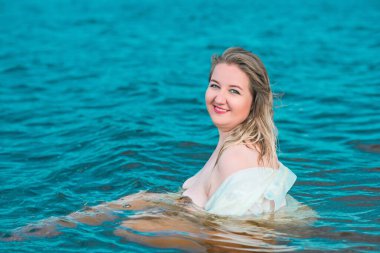 Beautiful plus size young woman rest at nature, concept of woman's life. Lady xl size having fun on a beach