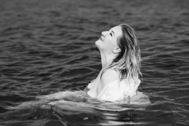 Beautiful plus size young woman rest at nature, concept of woman's life. Lady xl size having fun on a beach