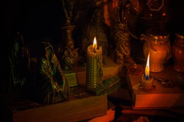 Illustration of magical stuff....candle light, magic wand, book of spells dark background, magic school, dark aesthetic, Halloween time