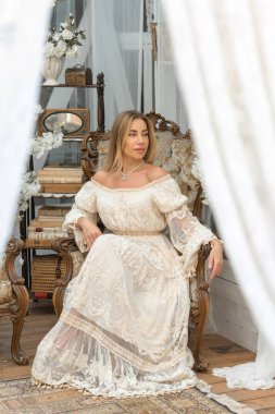 Dantelli, kayısı desenli elbisesi olan sarışın güzel bir kadın. Düğün ve akşam elbisesi konsepti