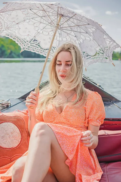 Tourist Pretty blonde woman on a boat. Romantic scene, vacation nice moments