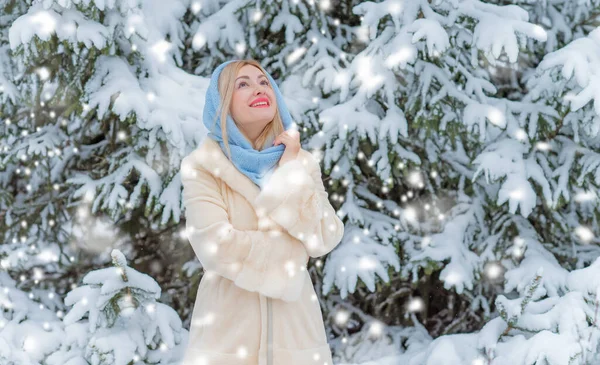 Dışarıda, karlı bir günde, kalın yün elbiseli sarışın bir kadın. Romantik stil