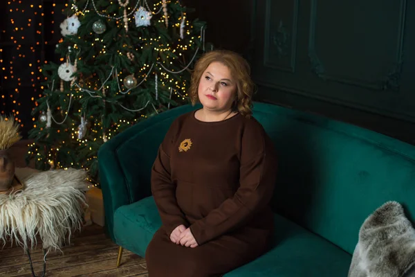Plus size mature lady celebrate Christmas or New Year. Portrait of European older woman at cozy home