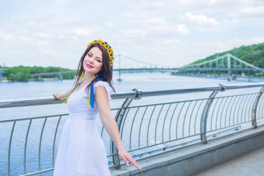 Şehir merkezinde sıradan giyinmiş bir kadın, saçında çiçek çelengi. Güzel Avrupalı kız kavramı, romantik tarz.