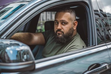 Arabadaki sakallı adamların portresi, yaklaşın. Otomobilli adam. Hobi kavramı, arabalar.