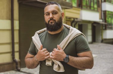 Kıyafet modası, yakışıklı bir adamın portresi. Şık tişörtlü, kot pantolonlu Avrupalı yarı Arap erkekler.