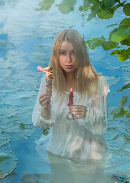 Stock image Old European magic, Mystical Pagan scene, woman in lake, rituals. Magic divination in water, rite