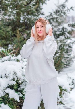 Beyaz yünlü kostüm, spor giysi ve kabarık kulaklar içinde sevimli bir kız.