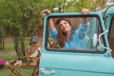 Mavi tişörtlü, beyaz etekli, açık hava resimli güzel bir Avrupalı yarı Latin kadın. 