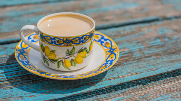 Vintage lemon tea cup on blue tray. Mediterranean summer concept