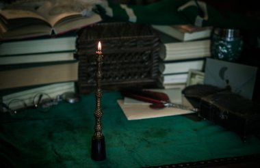 Karanlık akademi konsepti. Masada ders çalışmak ve kitap okumak.