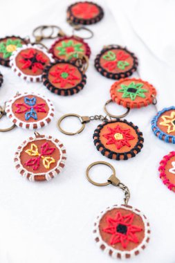 Close-up of a terracotta keychain with 8-pointed star pattern, crafted with a focus on color contrast and intricate detailing, ideal for gifting or adding a unique touch to everyday items clipart