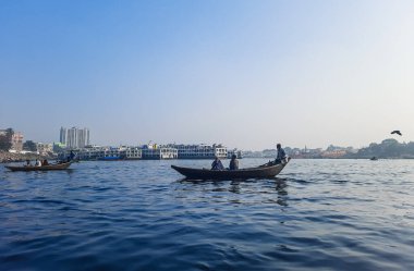 Sadarghat nehri manzarası, nehirden geçen küçük tekneler, muson yağmurlarında banliyö feribotu, Buriganga nehrinde tekne gezisi..