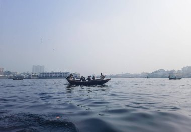 Sadarghat nehri manzarası, nehirden geçen küçük tekneler, muson yağmurlarında banliyö feribotu, Buriganga nehrinde tekne gezisi..